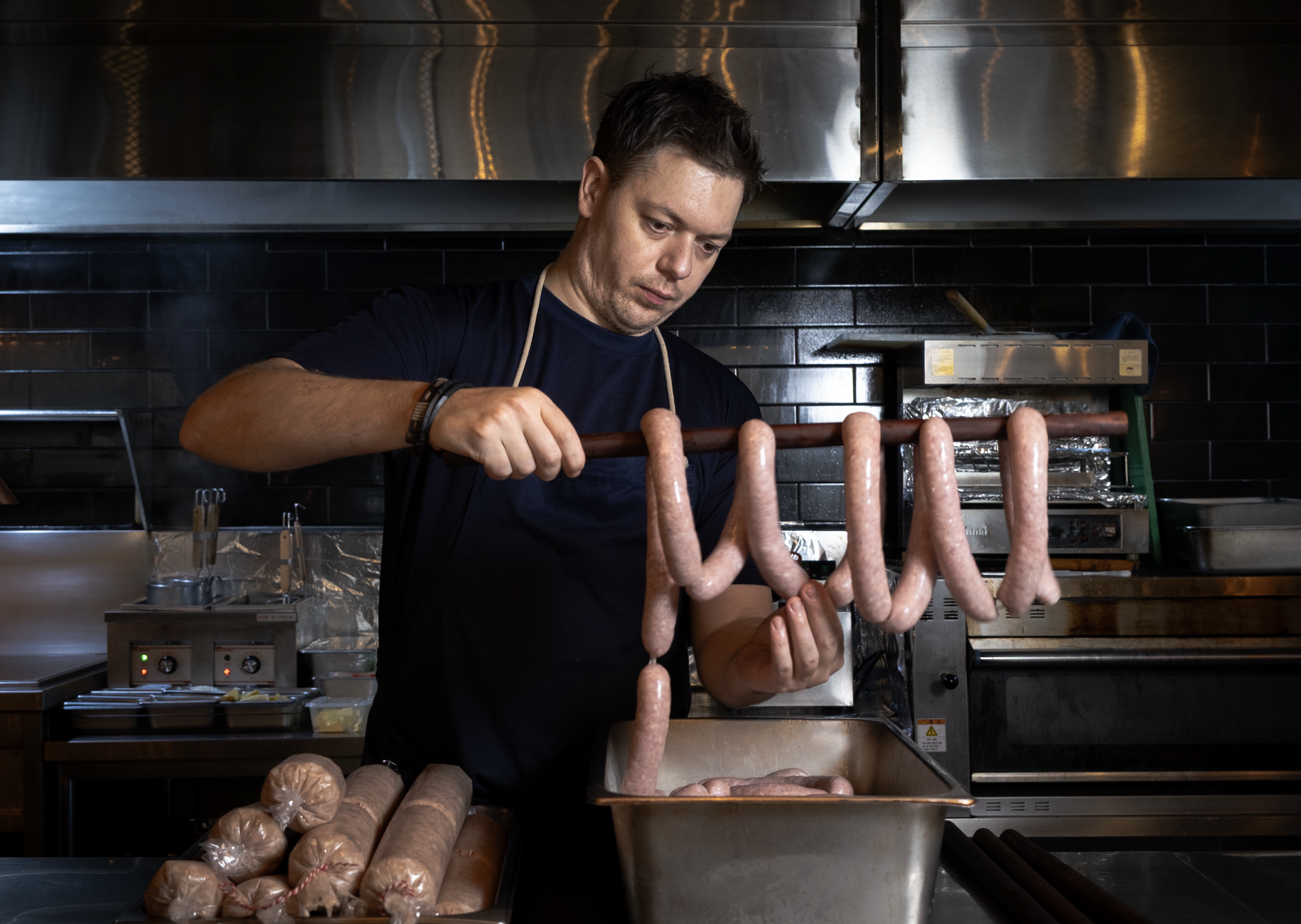 Chef Max preparing handmade gourmet sausages at Deli by Iluka in Jeonju